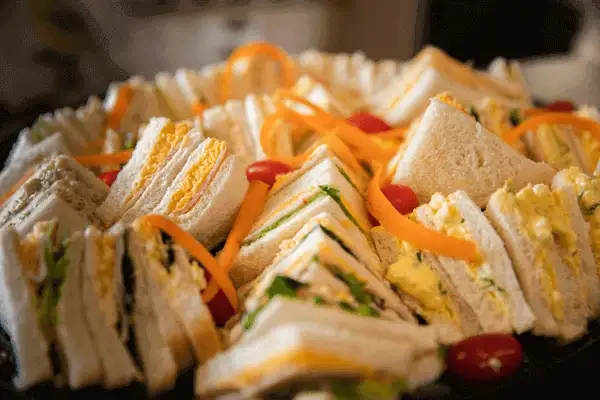 Close up of a plate with a variety of sandwiches to show the top 5 sandwich toppings for your next corporate event