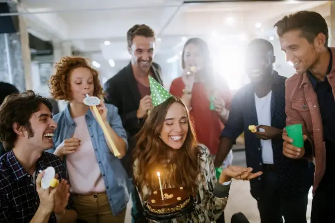 A woman celebrating her 30th birthday with her friends, as they eat snacks from grazing board.