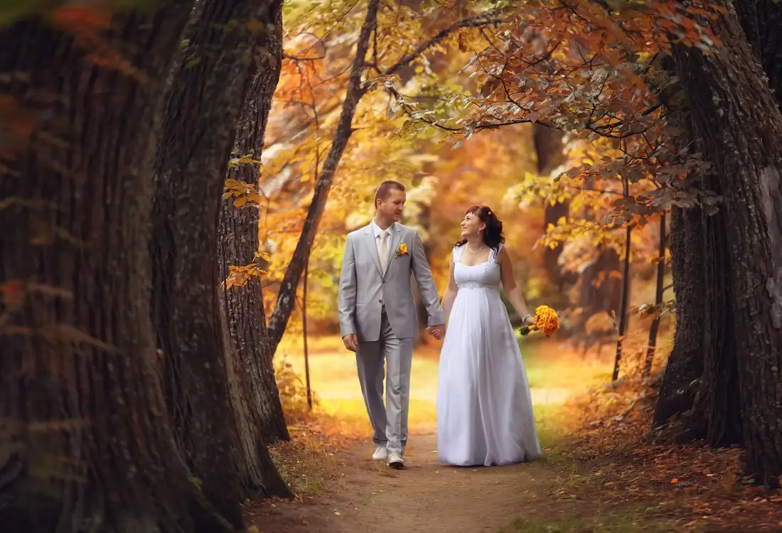 A couple celebrating their marriage to show why they chose to have an autumn wedding in Nottingham.