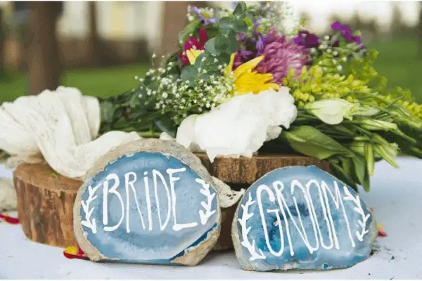 A close of flowers and a bride and groom display to show why summer is the most popular time for a wedding