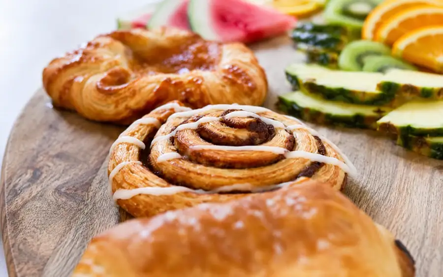 Croissants and Danish pastries arranged on a serving platter