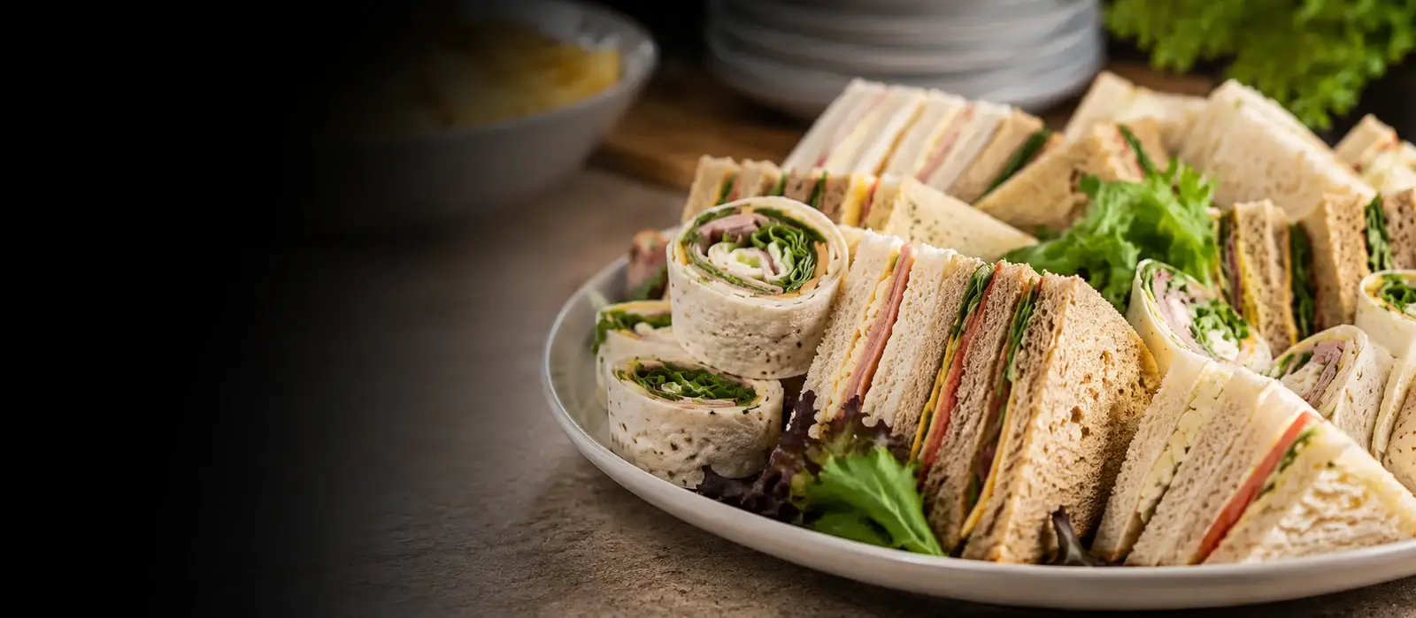 Freshly made sandwiches, salads and sharing platters laid out on a buffet table