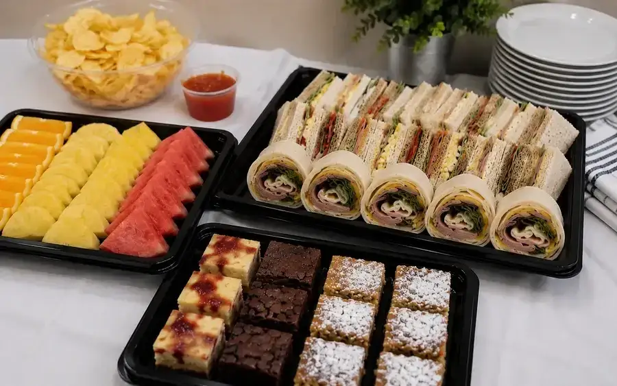 A cold buffet of sandwiches, savouries and salads laid out on a table