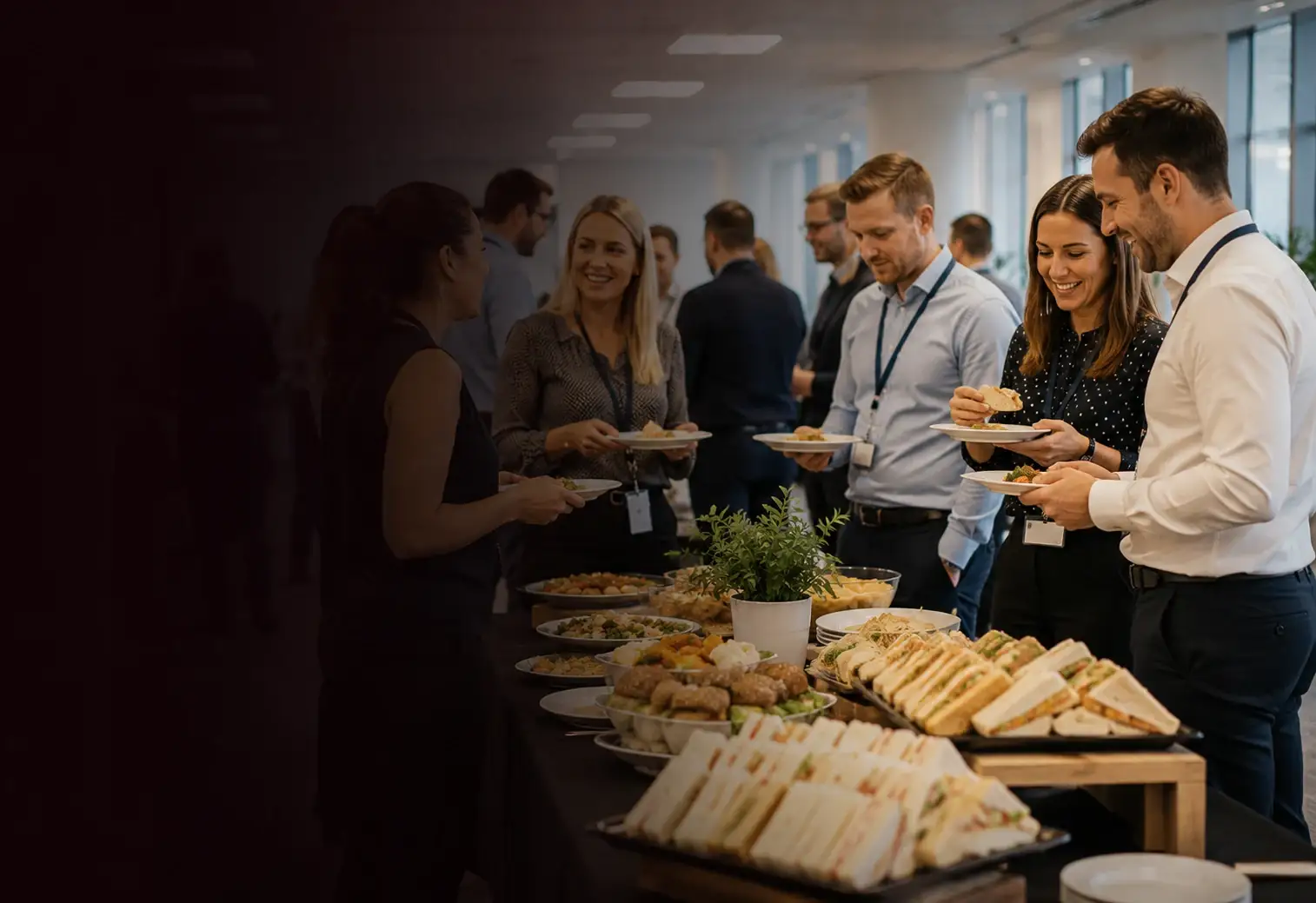 Office buffet of sandwich platters and salads set out in a meeting room