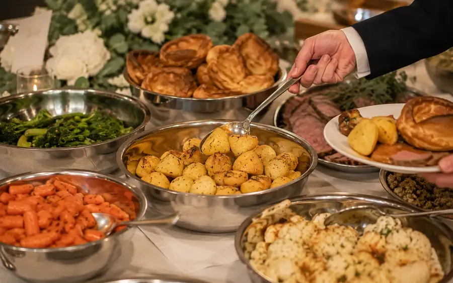 Guests helping themselves from a grazing spread laid along the table