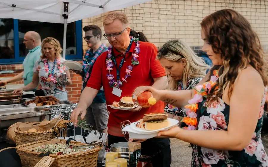 Guests helping themselves at a party buffet table
