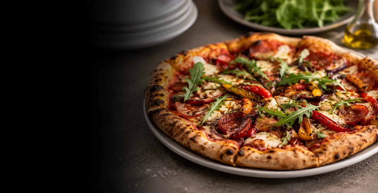 Freshly fired pizzas being served from the mobile oven at an evening event
