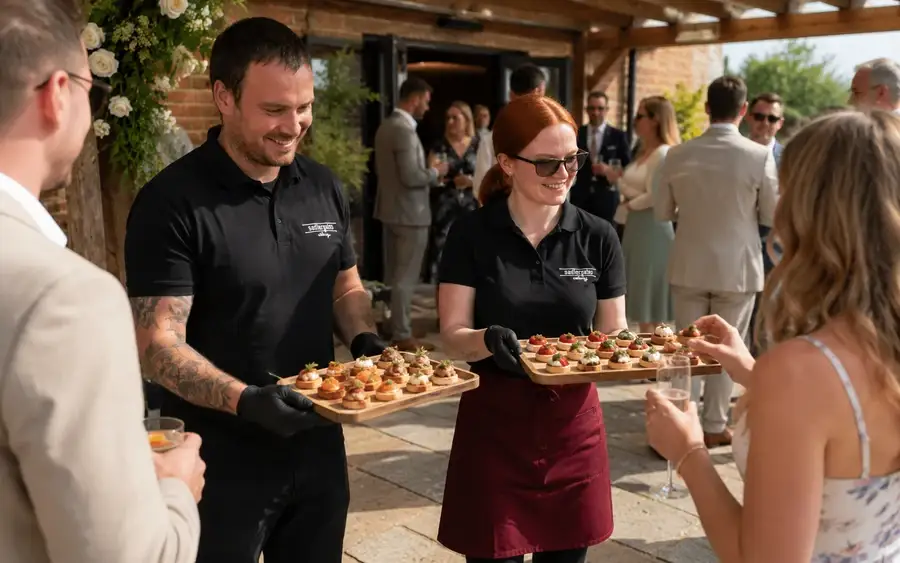 Guests being served at a wedding evening buffet