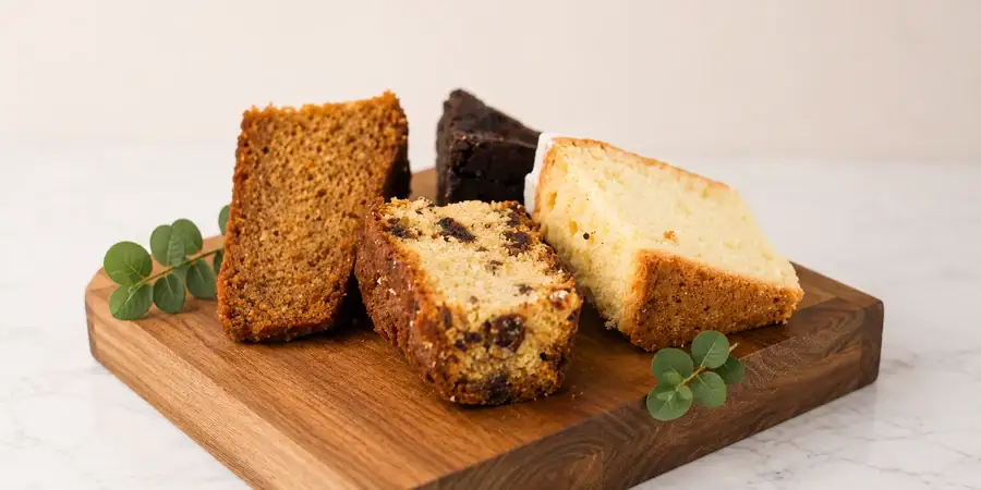 Sliced homemade cakes including brownies and lemon drizzle