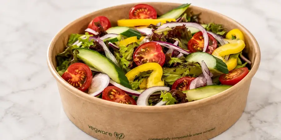 Bowl of freshly dressed salad with mixed leaves