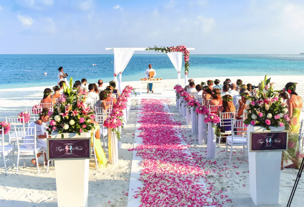 Choose a summer wedding by the beach for better weather and a colouful aisle