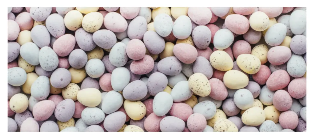 A close-up of pastel speckled mini chocolate eggs