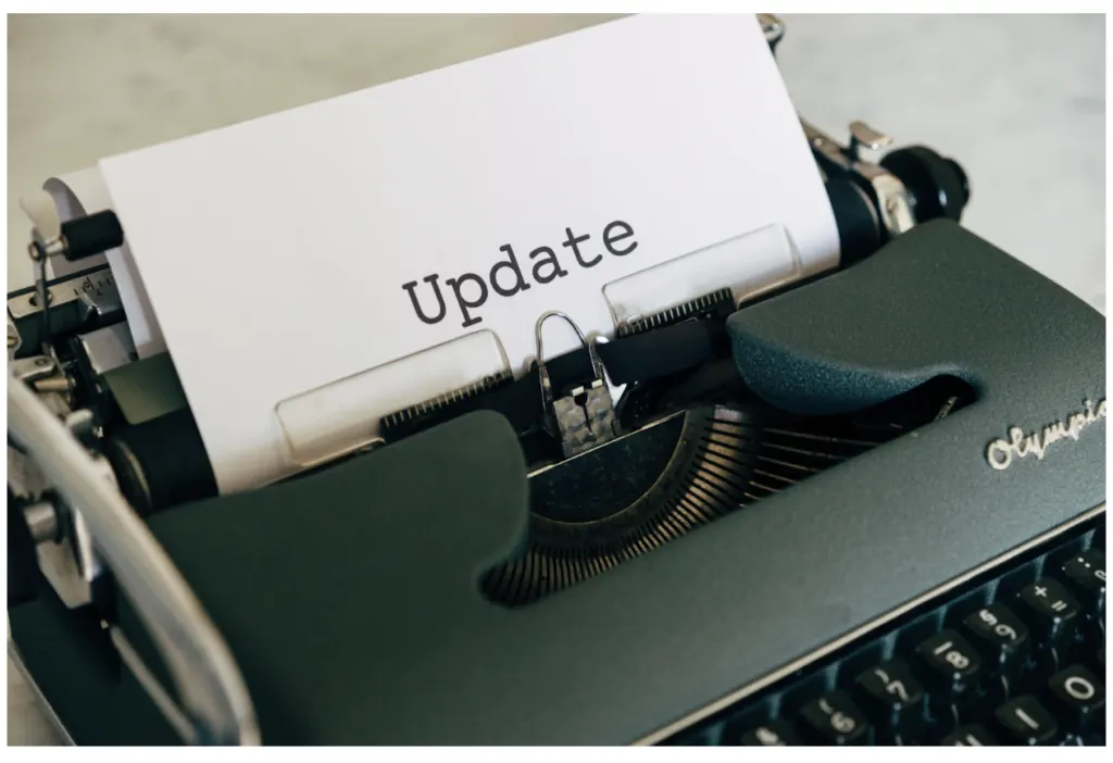 A typewriter with a sheet of paper in it bearing the single word Update