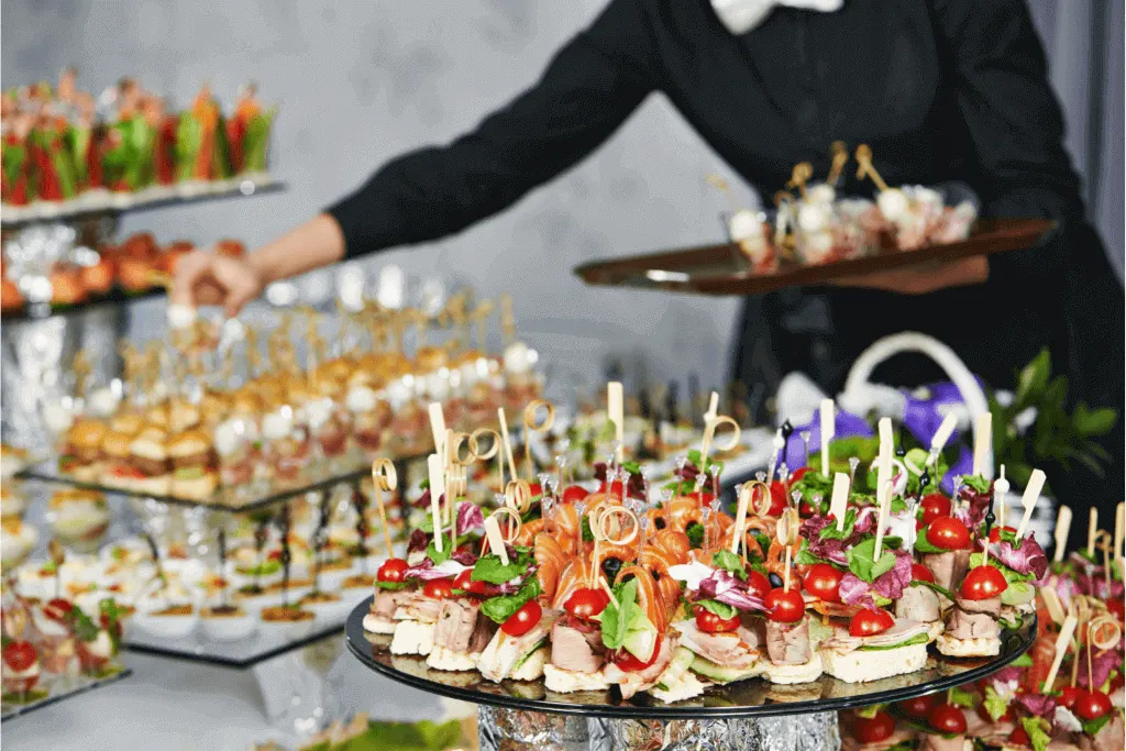 A caterer laying out a big spread of food for a wedding and party taster session