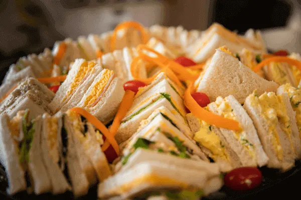 Close up of a plate with a variety of sandwiches to show the top 5 sandwich toppings for your next corporate event